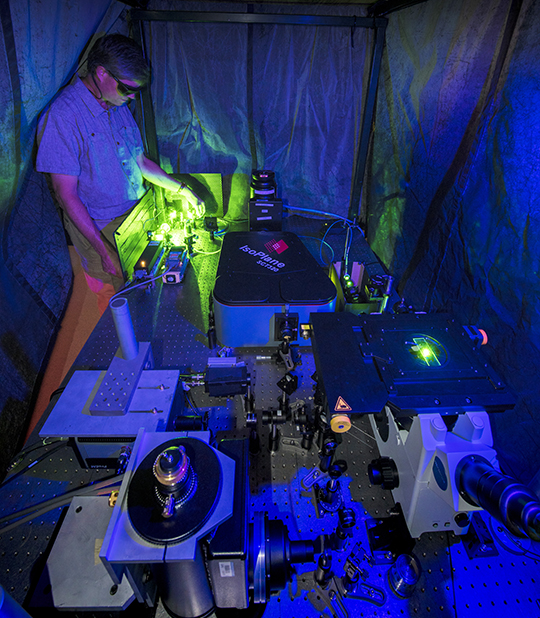 Photo. Steve Doorn works on an instrument used for spectroscopic characterization of carbon nanotubes.